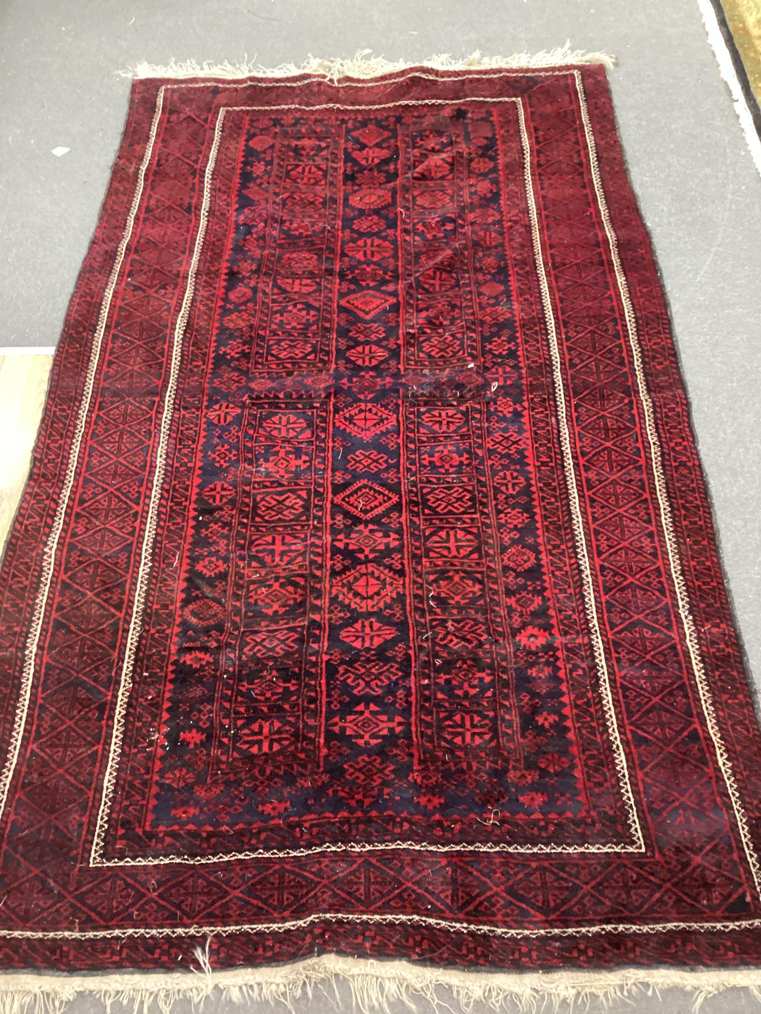 A Belouch blue ground geometric rug, 244cm x 120cm